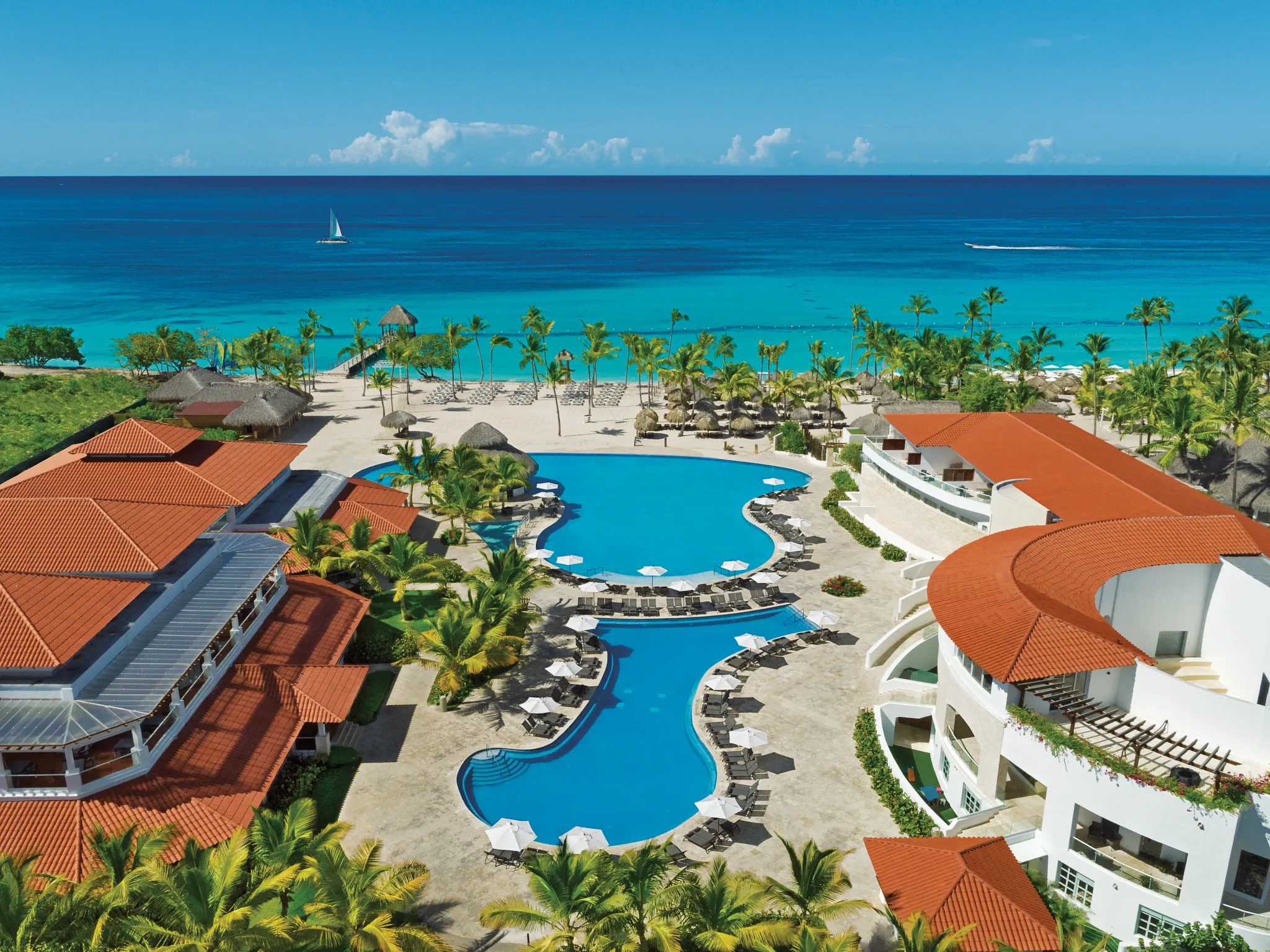 Aerial panoramic view of pools and beachfront at Dreams Dominicus La Romana Resort.