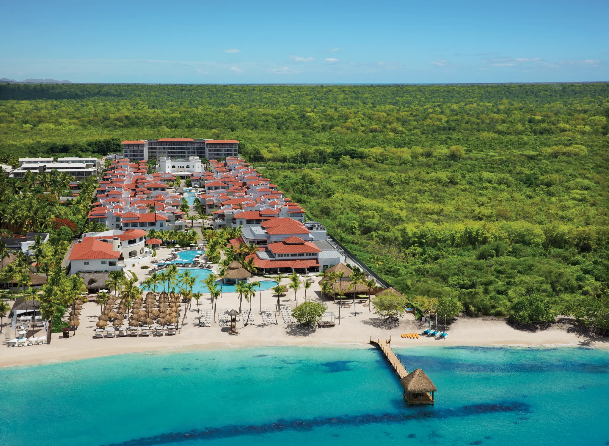 Aerial view of Dreams Dominicus La Romana beachfront resort and turquoise Caribbean waters.