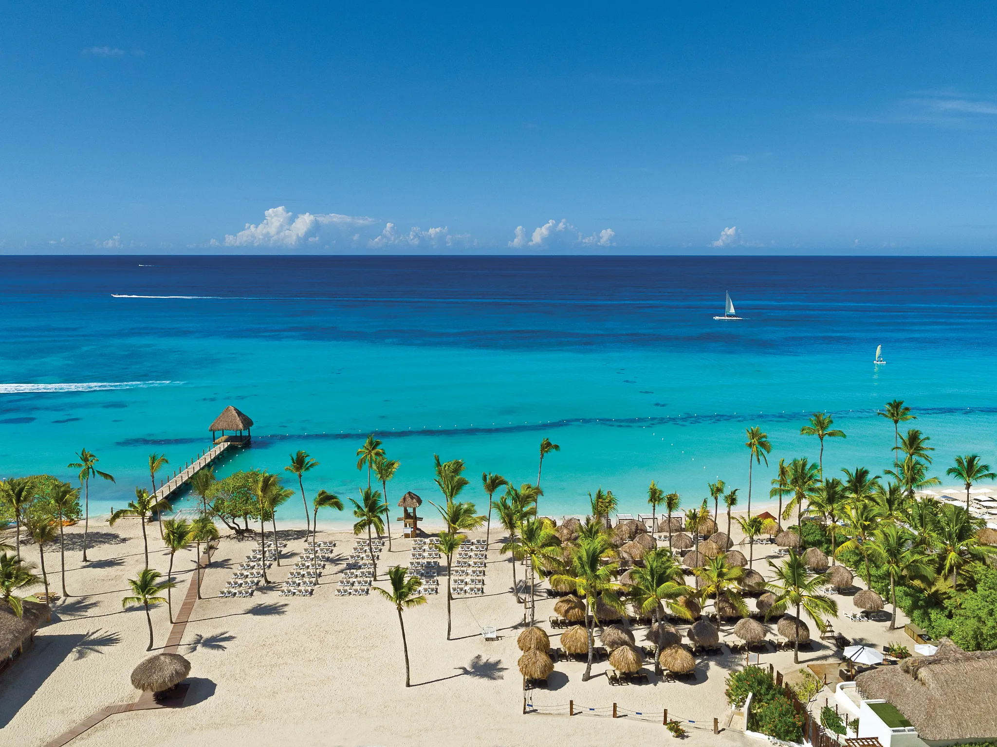 White-sand beach and turquoise ocean at Dreams Dominicus La Romana Resort in the Dominican Republic.