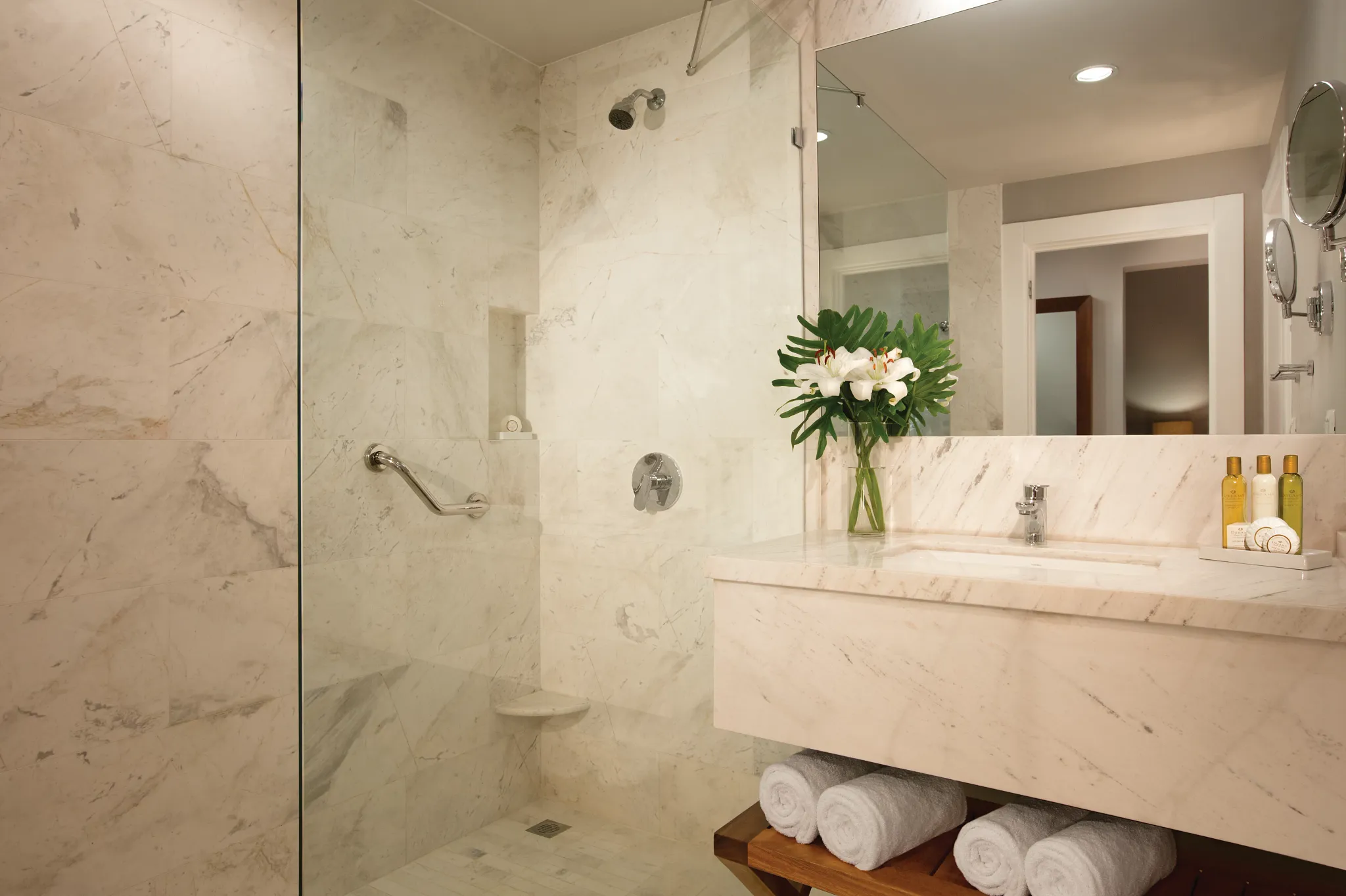 Deluxe Suite Tropical View bathroom with marble walk-in shower and modern vanity at Dreams Dominicus La Romana Resort.