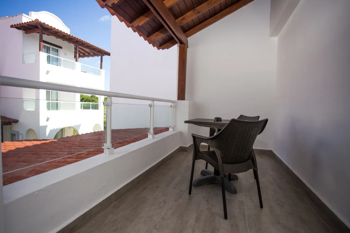 Private furnished terrace at Deluxe Suite Tropical View room at Dreams Dominicus La Romana overlooking the resort gardens.