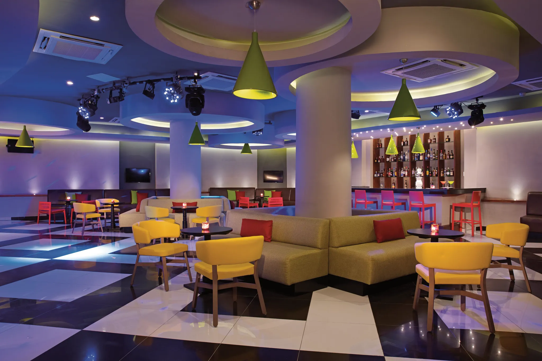 Desires nightclub at Dreams Dominicus La Romana featuring vibrant lighting, modern lounge seating, and energetic late-night entertainment.