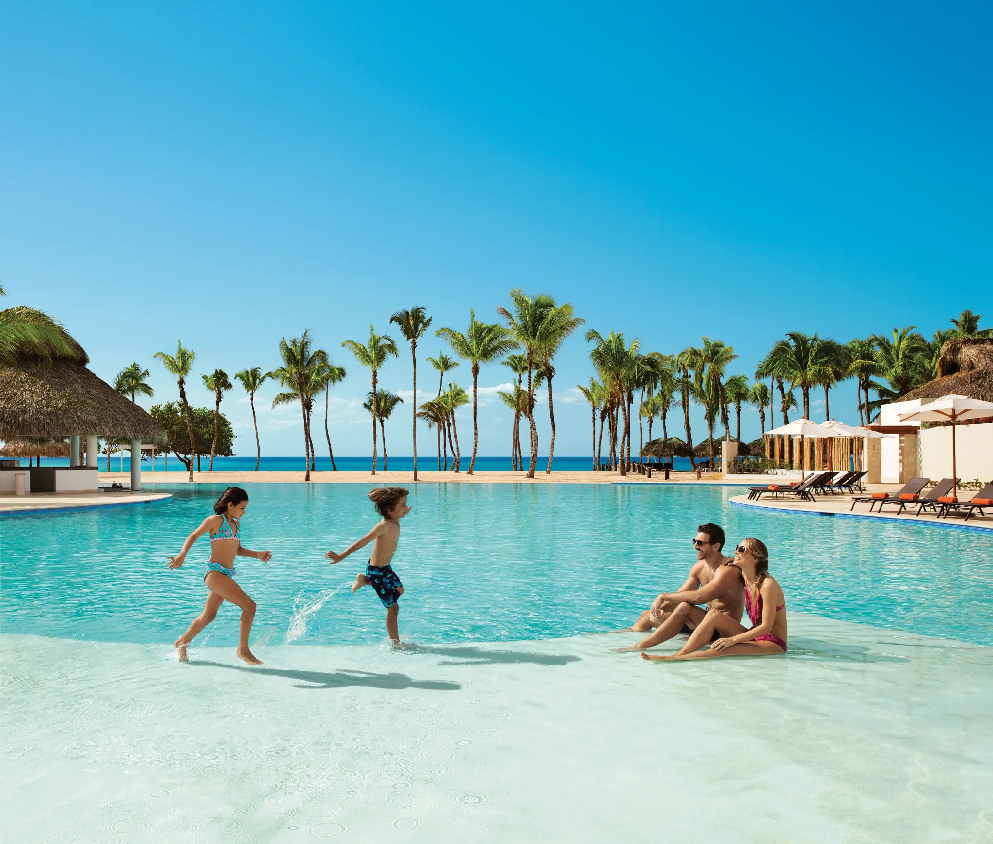 Family enjoying shallow pool activities at Dreams Dominicus La Romana Resort.