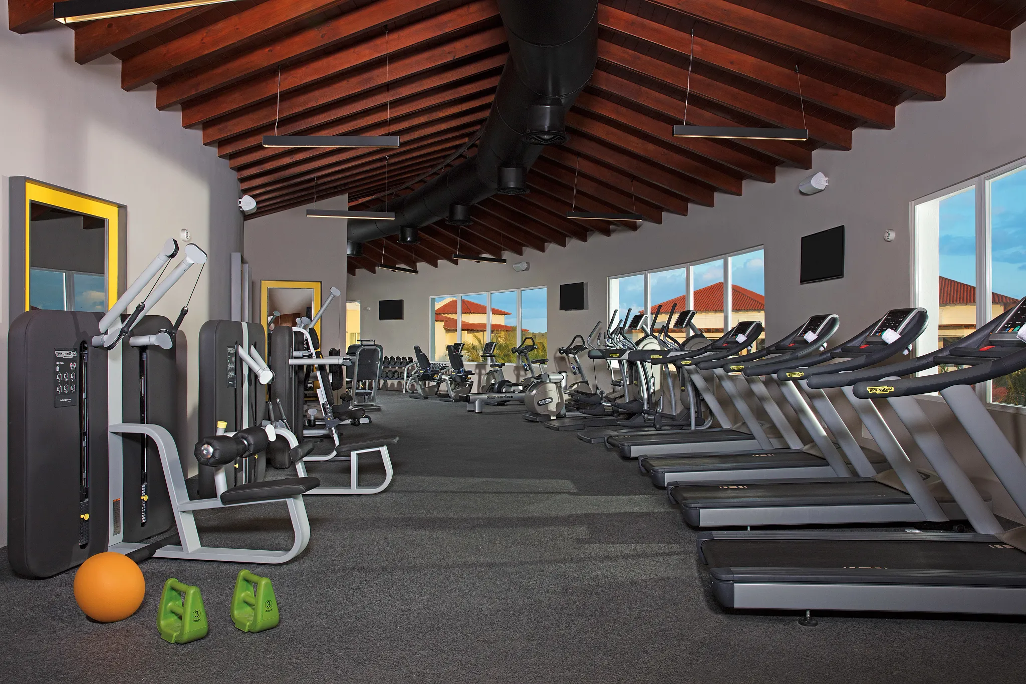 Modern fitness center with cardio and strength equipment at Dreams Dominicus La Romana Resort.