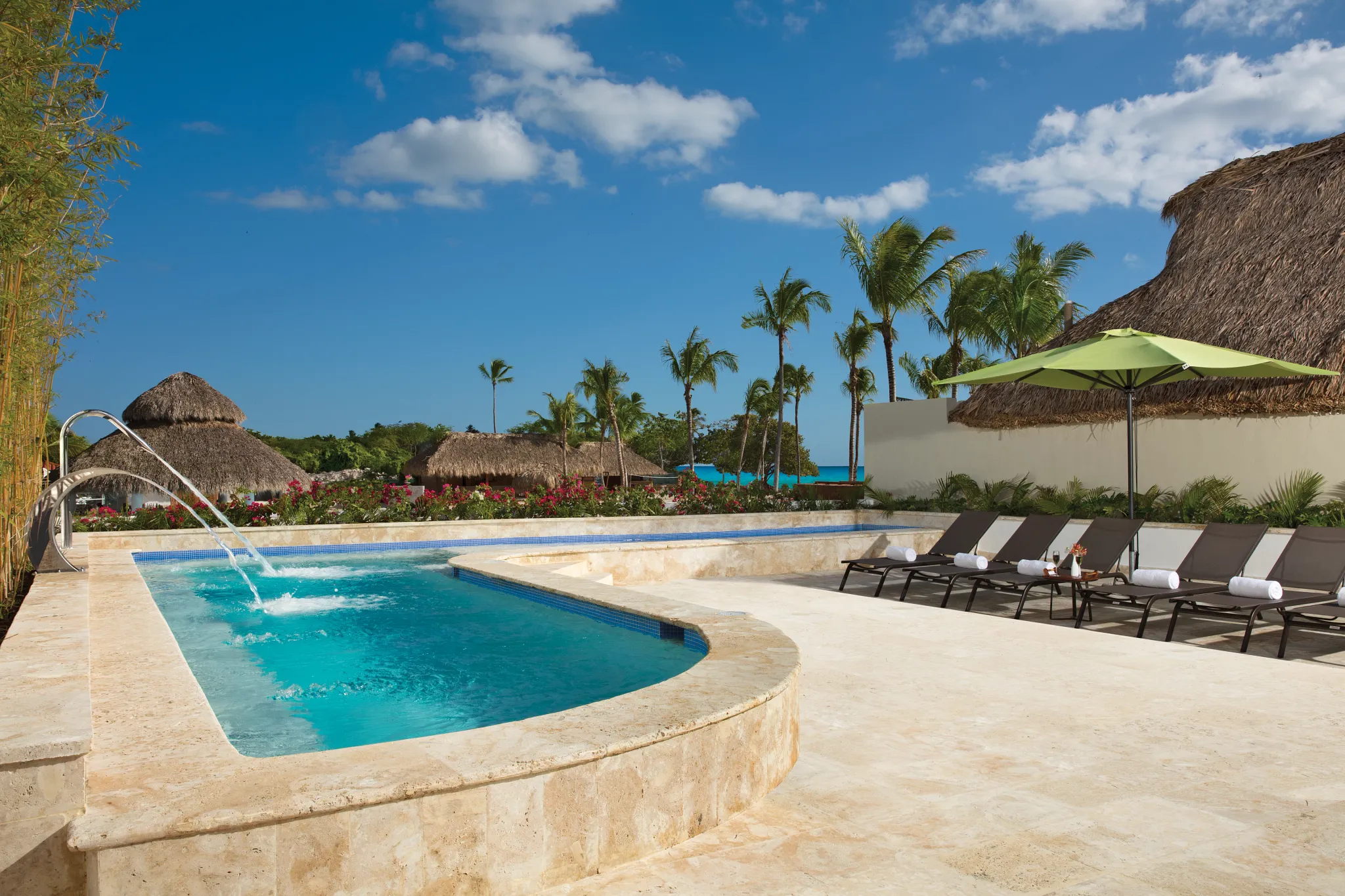 Outdoor hydrotherapy spa pool with lounge chairs at Dreams Dominicus La Romana Resort.