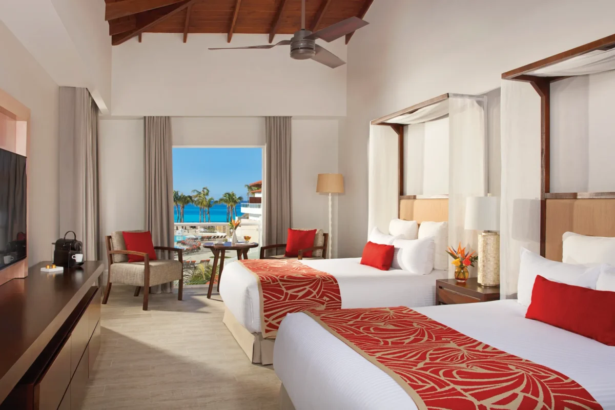 Preferred Club Deluxe Pool View room with two double beds and tropical pool views at Dreams Dominicus La Romana Resort.