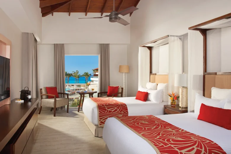 Preferred Club Deluxe Pool View room with two double beds and tropical pool views at Dreams Dominicus La Romana Resort.