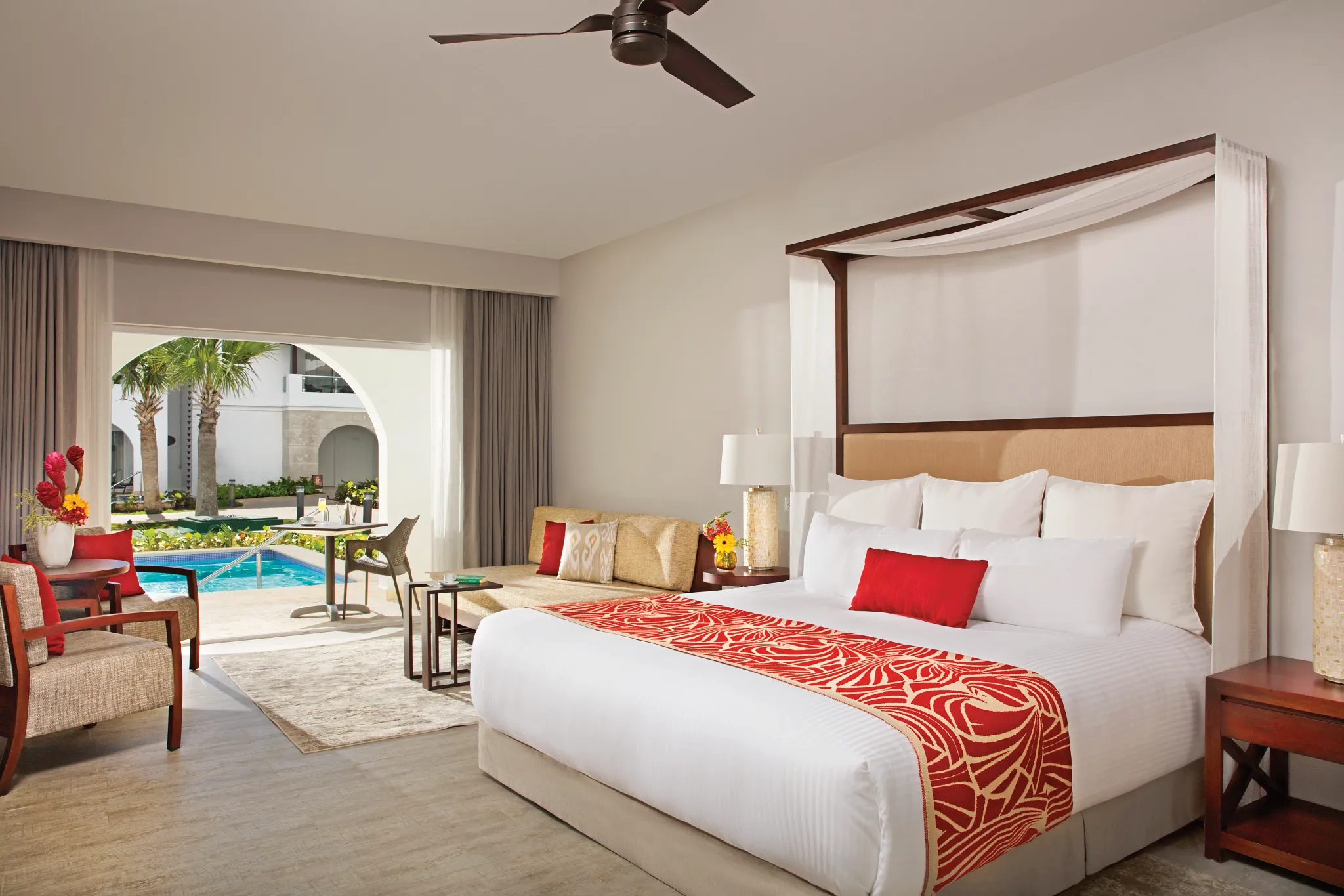 Preferred Club Deluxe Swim-Up room with king bed and furnished terrace at Dreams Dominicus La Romana Resort.