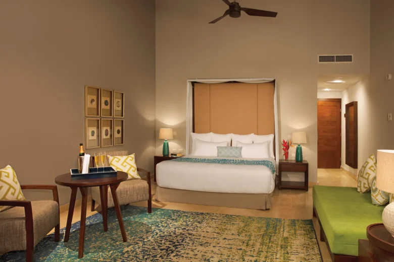 Preferred Club Honeymoon Suite with king bed and sitting area at Dreams Dominicus La Romana Resort.