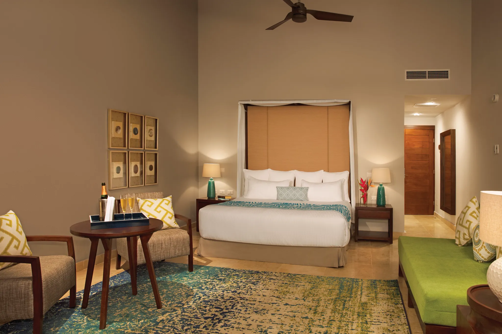 Preferred Club Honeymoon Suite with king bed and sitting area at Dreams Dominicus La Romana Resort.