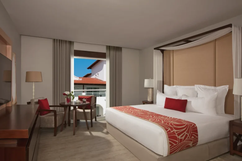 Preferred Club Suite Tropical View with king bed and private balcony at Dreams Dominicus La Romana Resort.