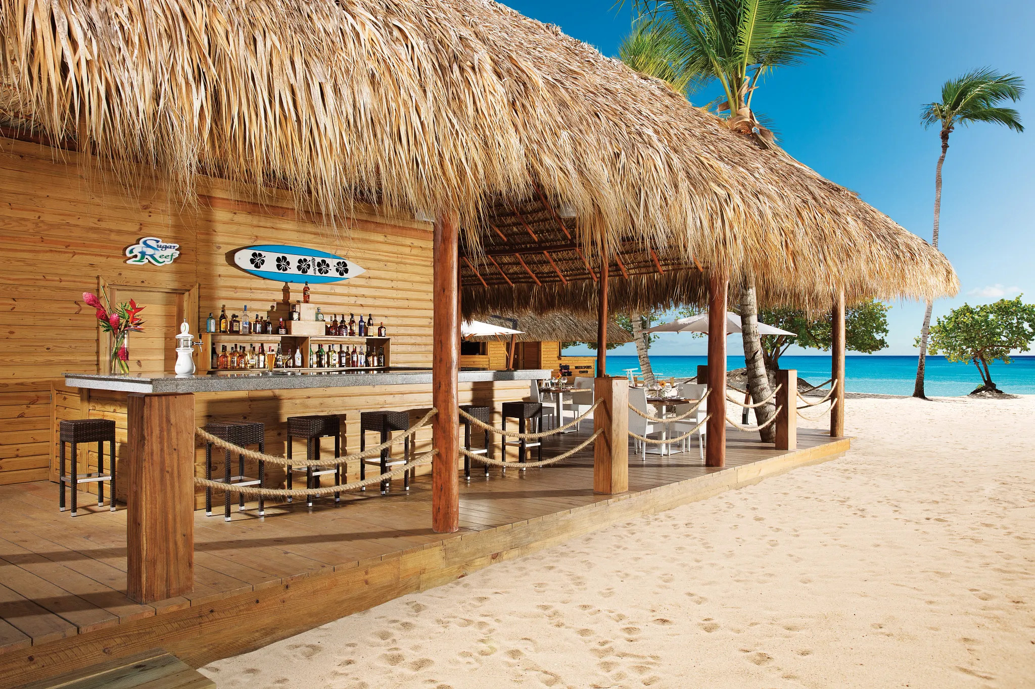 Sugar Reef pool bar at Dreams Dominicus La Romana featuring tropical cocktails, swim-up seating, and relaxed resort pool atmosphere.